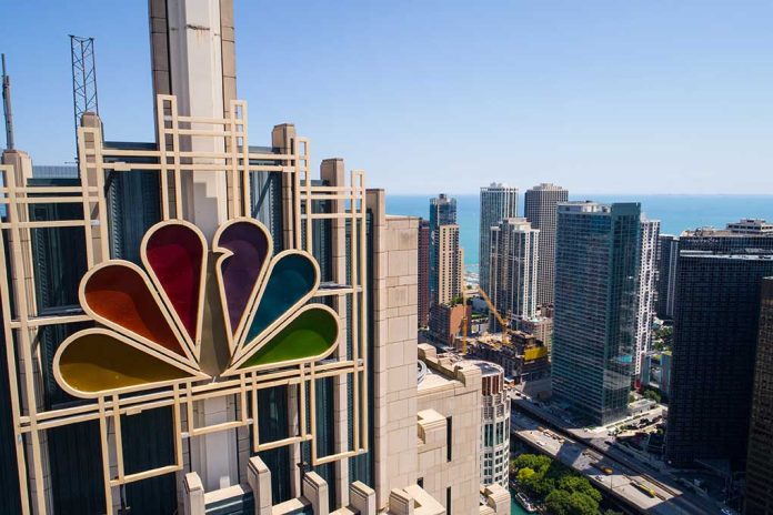 Colorful peacock logo on high-rise building overlooking city.