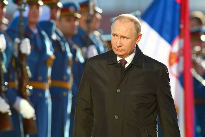 A man in dark coat at a military event.