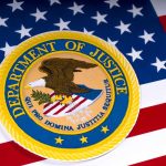 Department of Justice emblem on the American flag.