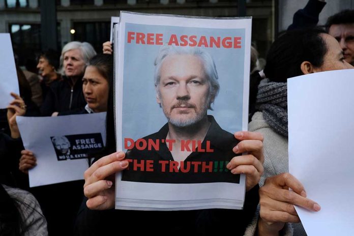 Protesters holding signs supporting Julian Assange.