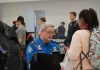 TSA agent checks passenger's documents at airport security.