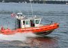 Coast Guard boat speeding on the water.