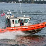 Coast Guard boat speeding on the water.