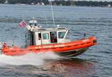 Coast Guard boat speeding on the water.