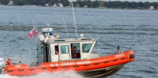 Coast Guard boat speeding on the water.