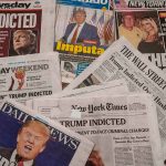 Newspaper headlines about Trump's indictment.