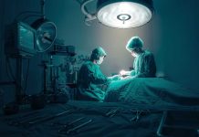 Surgeons performing an operation under bright lights.