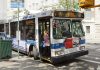 Person boarding clean air hybrid electric city bus.