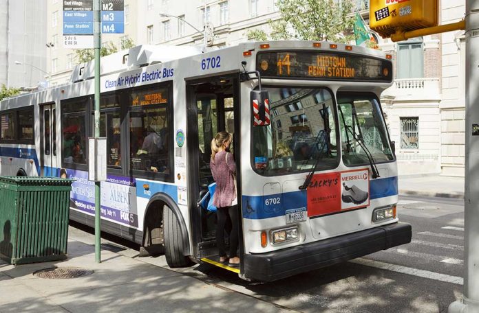 Person boarding clean air hybrid electric city bus.