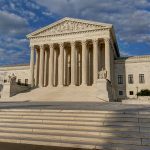 Supreme Court building with steps and columns.