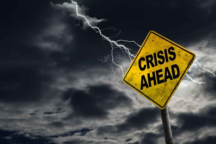 Yellow "Crisis Ahead" sign with stormy sky.