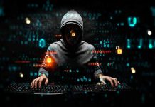 Hacker in hoodie using computer with digital code background.