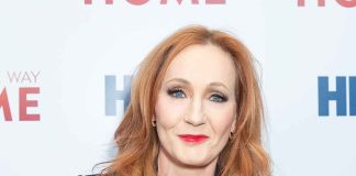 Woman with red hair smiling at an event.