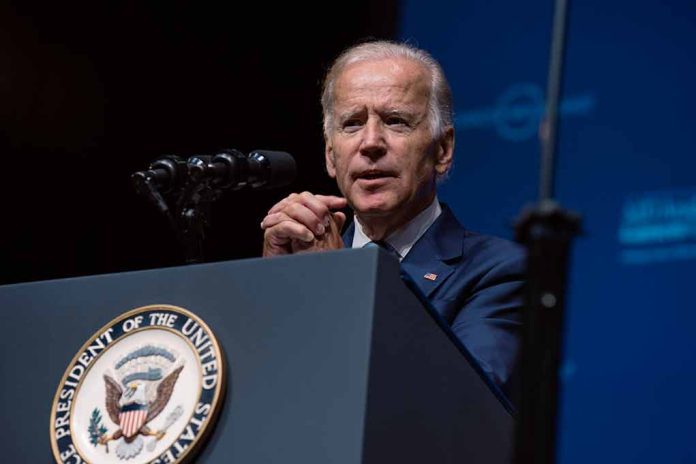 Man speaking at a podium with microphones.