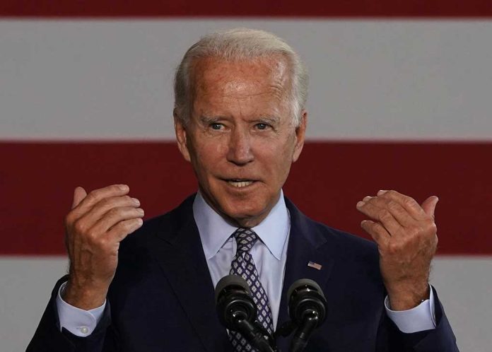 Man speaking with American flag background.