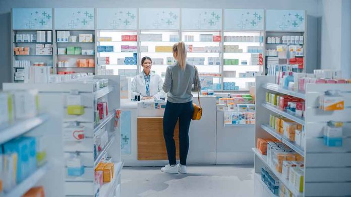 Customer talking to pharmacist at a bright pharmacy.