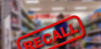 "Recall" stamp on blurred store aisle background.