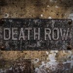 Weathered Death Row sign on aged concrete wall