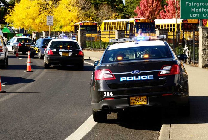 Police cars and school buses on a road.