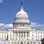 U.S. Capitol building against blue sky.