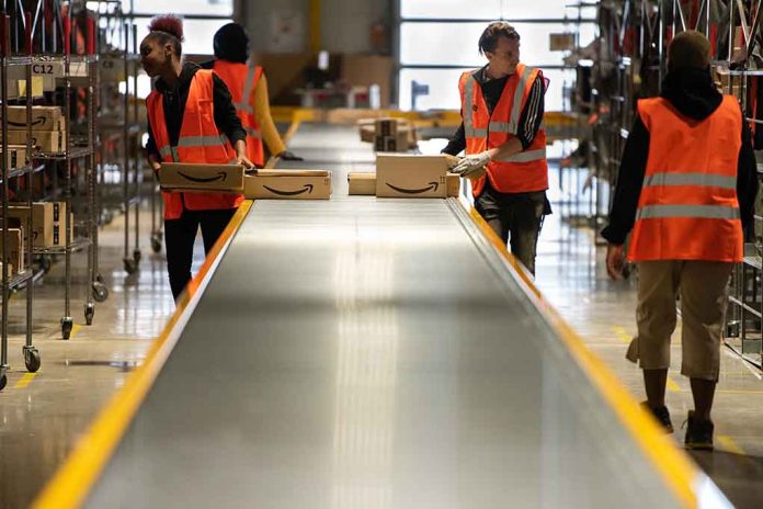 Workers in warehouse sorting packages on conveyor.