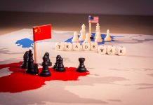 Chess pieces and flags on trade war map