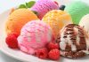 Assorted ice cream scoops with raspberries on a plate