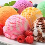 Assorted ice cream scoops with raspberries on a plate