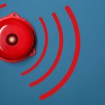 Red alarm bell on a blue background