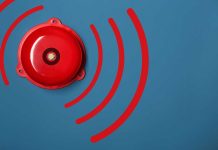 Red alarm bell on a blue background