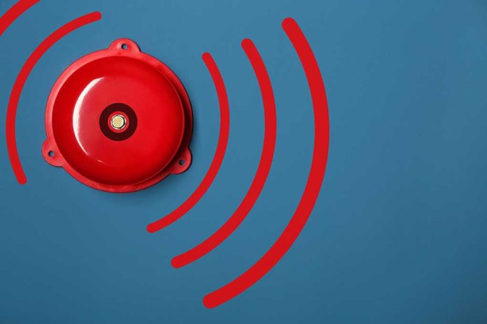1311134939 featured image Red alarm bell on a blue background