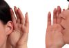 Person whispering into another persons ear gesture