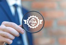 Person holding magnifying glass with FDA logo
