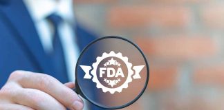 Person holding magnifying glass with FDA logo