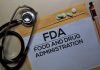 Stethoscope and FDA documents with pills and pen