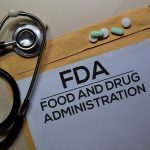 Stethoscope and FDA documents with pills and pen