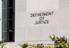 Department of Justice building exterior with window and plants