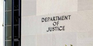 Department of Justice building exterior with window and plants