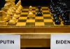 Chessboard labeled Putin and Biden, pieces set up.