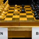 Chessboard labeled Putin and Biden, pieces set up.