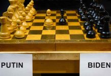 Chessboard labeled Putin and Biden, pieces set up.