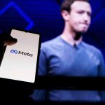 Person holding smartphone with Meta logo displayed
