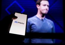Person holding smartphone with Meta logo displayed