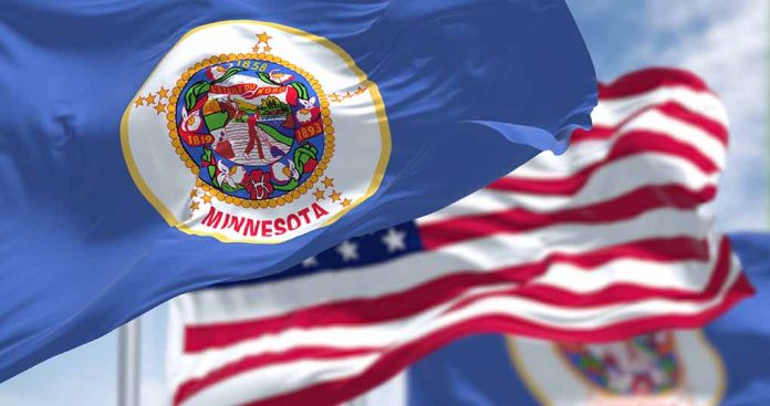 2165286029 featured image Minnesota state flag with American flag in background