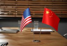 American and Chinese flags on a conference table