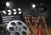 Movie set with film reels and clapperboard