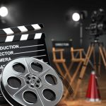 Movie set with film reels and clapperboard