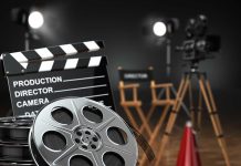 Movie set with film reels and clapperboard