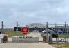 Chainlink fence with Restricted Area Stop No Photography sign