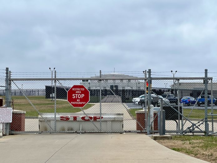 2375002113 featured image Chainlink fence with Restricted Area Stop No Photography sign